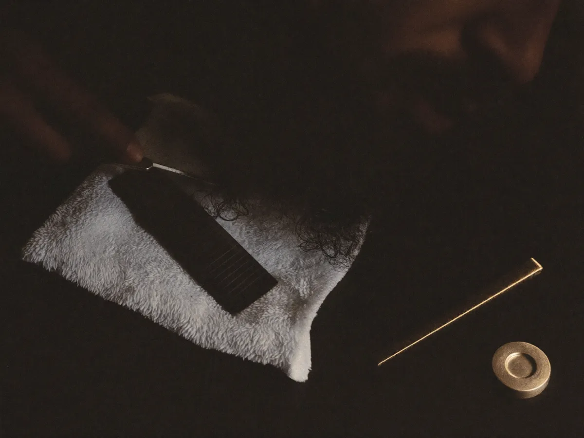 Towel, comb and brass on the counter